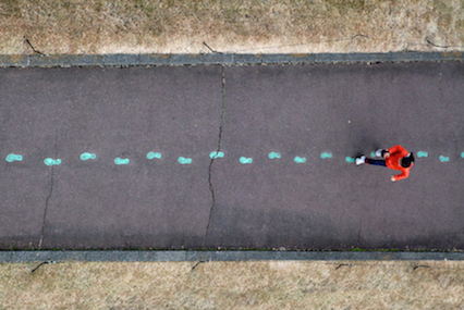 Image showing person walking in pre-marked footprints